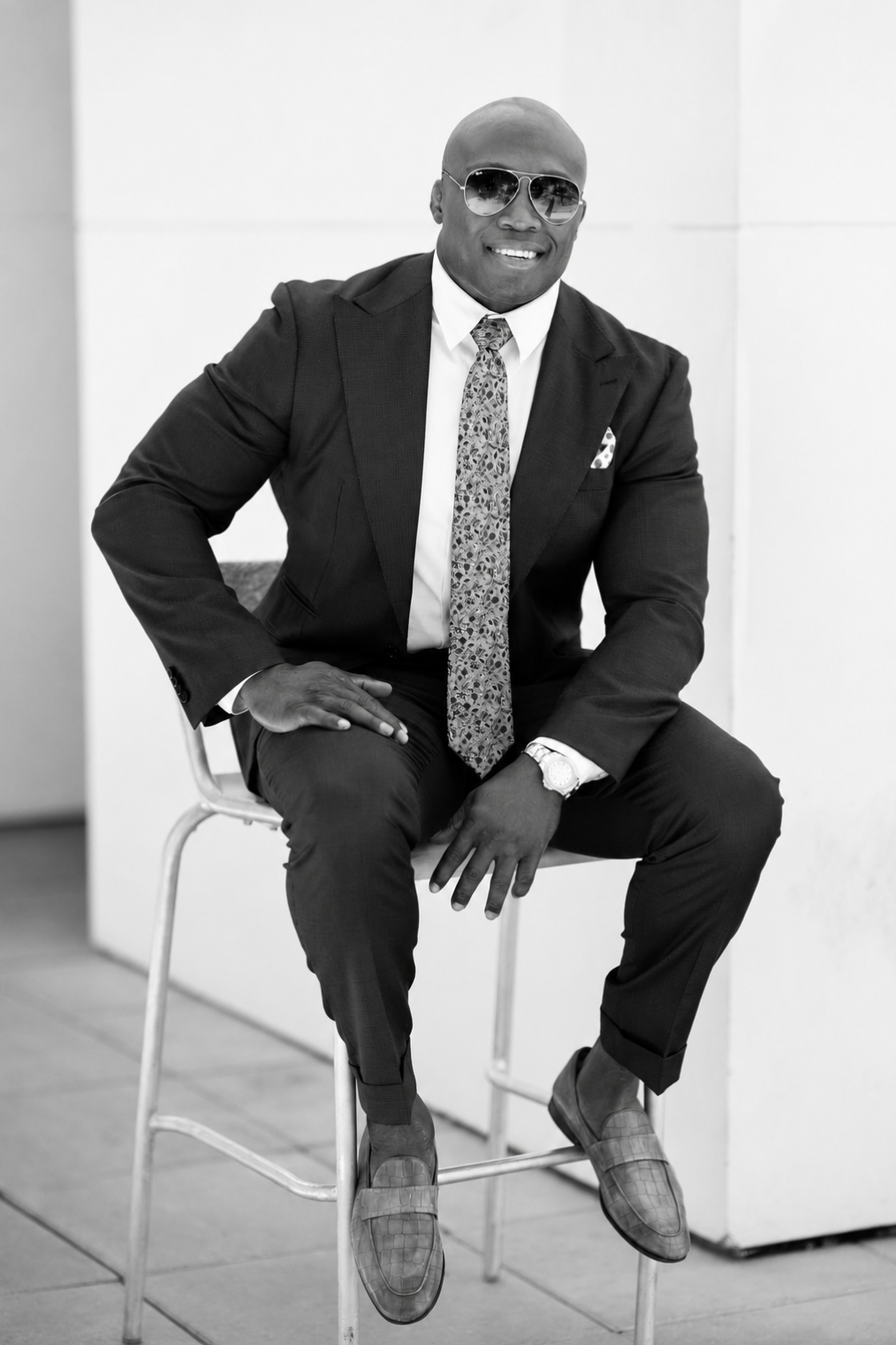 Bobby Lashley in a tailored suit seated for a video message