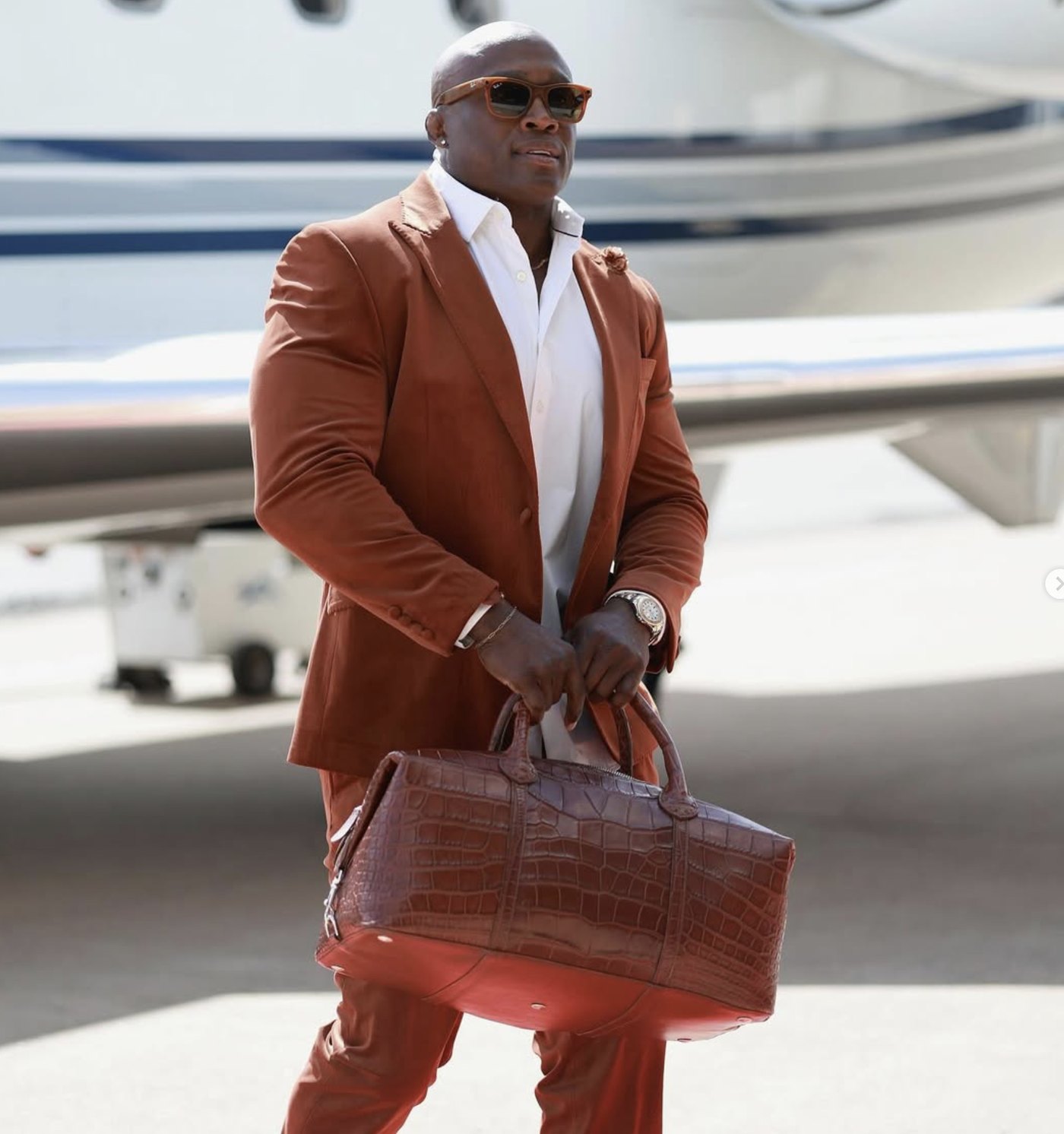 Bobby Lashley arriving in a tan suit