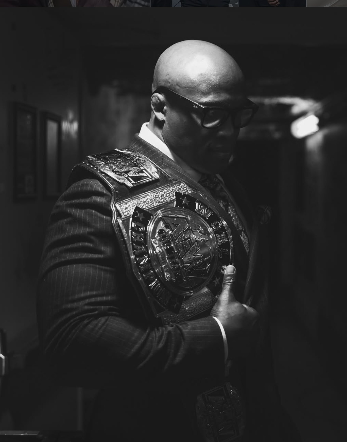 Bobby Lashley in a suit with a championship belt